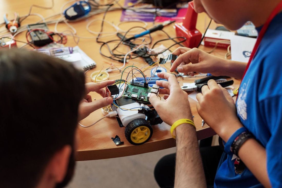 Boy His Mentor Working On Raspberry Pi and Arduino Project.